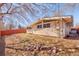 Backyard featuring rocks, grass and the home's exterior with surrounding trees at 2370 S Meade St, Denver, CO 80219