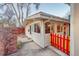 Backyard view of a cozy home with a colorful fence and inviting patio space at 2370 S Meade St, Denver, CO 80219