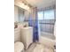 Bright bathroom featuring a tub and shower combination, vanity and commode at 2370 S Meade St, Denver, CO 80219