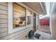 View of bedroom through sliding glass doors to outside patio with green hose and red fence at 2370 S Meade St, Denver, CO 80219