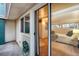 View of bedroom through sliding glass doors to outside patio with green hose at 2370 S Meade St, Denver, CO 80219