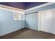 Neutral bedroom with blue accent wall, carpeting, and sliding closet doors at 2370 S Meade St, Denver, CO 80219