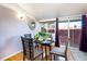 Cozy dining area featuring hardwood floors and sliding glass doors for natural light at 2370 S Meade St, Denver, CO 80219
