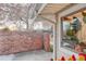 Exterior shot showcasing the property's brick accent wall and natural light, enhancing its curb appeal at 2370 S Meade St, Denver, CO 80219