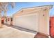 Detached garage with a pristine white door and a well-kept exterior, providing ample parking and storage space at 2370 S Meade St, Denver, CO 80219