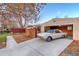 View of garage with a classic white car inside, highlighting the property's unique charm and ample parking at 2370 S Meade St, Denver, CO 80219