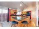 Open kitchen with island, black appliances, granite counters and colorful backsplash at 2370 S Meade St, Denver, CO 80219