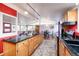 Open concept kitchen boasts an island, oak cabinets and black countertops at 2370 S Meade St, Denver, CO 80219