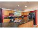 Bright kitchen featuring oak cabinets, stainless appliances, and black countertops at 2370 S Meade St, Denver, CO 80219