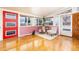 Bright living room with large windows, hardwood floors, and a red front door, creating an inviting atmosphere at 2370 S Meade St, Denver, CO 80219
