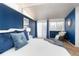 Comfortable main bedroom with accent wall, natural lighting, and sliding glass doors at 2370 S Meade St, Denver, CO 80219