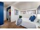 Bright main bedroom with ensuite bathroom, ample windows, and a comfortable bed dressed in white linens at 2370 S Meade St, Denver, CO 80219