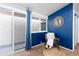 Comfortable main bedroom with accent wall, natural lighting, and sliding glass doors at 2370 S Meade St, Denver, CO 80219