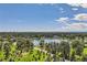 Stunning aerial view of a park with lake and lush greenery and city skyline beyond at 480 S Marion Pkwy # 1601, Denver, CO 80209