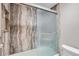 Bathroom shower featuring modern glass door and stone-look walls at 480 S Marion Pkwy # 1601, Denver, CO 80209