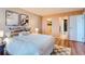 Bedroom with a view of the closet and bathroom featuring hardwood floors and neutral paint at 480 S Marion Pkwy # 1601, Denver, CO 80209