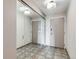 Neutral-toned hallway featuring mirrored closet doors and updated lighting at 480 S Marion Pkwy # 1601, Denver, CO 80209