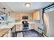 Well-lit kitchen with stainless steel appliances and light wood cabinetry at 480 S Marion Pkwy # 1601, Denver, CO 80209