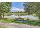 A tranquil park scene with a bench overlooking a serene lake, framed by lush greenery and trees at 480 S Marion Pkwy # 1601, Denver, CO 80209