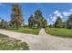 Scenic park view with a gravel path winding through green grass and mature trees, offering a tranquil setting at 480 S Marion Pkwy # 1601, Denver, CO 80209