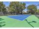 A vibrant blue and green tennis court stands ready for play, surrounded by lush greenery at 480 S Marion Pkwy # 1601, Denver, CO 80209