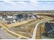 Scenic aerial view of a residential community showcasing well-maintained homes, pathways, and a picturesque landscape at 16890 Black Rose Pl, Parker, CO 80134