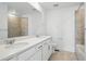 Bathroom featuring double sink vanity with white countertops and tiled shower/tub combination at 16890 Black Rose Pl, Parker, CO 80134