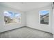 Bright bedroom with neutral carpet and three windows offering neighborhood views at 16890 Black Rose Pl, Parker, CO 80134