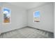 A bright bedroom with two windows and neutral-colored carpet at 16890 Black Rose Pl, Parker, CO 80134