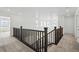 Upstairs hallway with dark brown railing and neutral carpet at 16890 Black Rose Pl, Parker, CO 80134