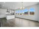 Modern kitchen featuring white cabinets, stainless steel appliances, a large island, and ample natural light at 16890 Black Rose Pl, Parker, CO 80134
