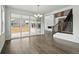 Open-concept living area with luxury vinyl plank flooring, a staircase, and a sliding glass door leading to the patio at 16890 Black Rose Pl, Parker, CO 80134