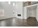 Open-concept living room featuring soaring ceilings, a modern fireplace, and luxury vinyl plank flooring at 16890 Black Rose Pl, Parker, CO 80134