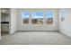 Spacious main bedroom with plush carpet flooring, and multiple windows offering scenic neighborhood views at 16890 Black Rose Pl, Parker, CO 80134