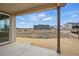 Covered patio area with serene views of the open field at 16890 Black Rose Pl, Parker, CO 80134