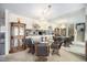 Dining room with a chandelier, round table, and wicker chairs at 3445 S Ammons St # 15-4, Lakewood, CO 80227