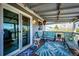 Inviting covered back deck featuring comfortable seating and string lights creating a cozy outdoor retreat at 862 Centennial Way, Bennett, CO 80102
