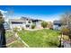 Expansive backyard with lush green grass, storage shed, and a patio area perfect for outdoor entertaining at 862 Centennial Way, Bennett, CO 80102