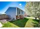 Backyard view with well-maintained lawn, partial fence, and mature trees, creating a private outdoor space at 862 Centennial Way, Bennett, CO 80102