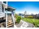 Backyard with a multi-level deck, lush lawn, storage shed, and mature landscaping providing ample outdoor space at 862 Centennial Way, Bennett, CO 80102