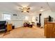 Finished basement area with tile flooring and a vintage fireplace, complemented by vintage shelving and desk space at 862 Centennial Way, Bennett, CO 80102