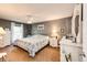 Bright bedroom showcasing a large window, dresser, and ceiling fan creating a relaxing atmosphere at 862 Centennial Way, Bennett, CO 80102