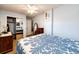 Cozy bedroom with blue walls, features a ceiling fan and a view into the closet and other room at 862 Centennial Way, Bennett, CO 80102