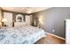 This bright main bedroom has a ceiling fan, carpet and mirrored dresser at 862 Centennial Way, Bennett, CO 80102