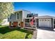 Charming two-story home featuring gray siding, brick accents, and a welcoming front porch at 862 Centennial Way, Bennett, CO 80102