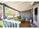 Cozy covered front porch with wicker furniture and decorative touches creating a relaxing outdoor space at 862 Centennial Way, Bennett, CO 80102