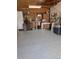 Spacious garage featuring painted floor, workbench, and storage, providing ample space for projects at 862 Centennial Way, Bennett, CO 80102