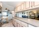 View of the kitchen featuring upper and lower cabinets with view to the dining area and living room for an open concept feel at 862 Centennial Way, Bennett, CO 80102