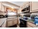 Traditional-style kitchen with stainless steel appliances, neutral countertops, and plenty of cabinet storage at 862 Centennial Way, Bennett, CO 80102