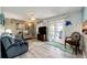Open concept living room with tile flooring, outdoor access through glass doors, and an airy and bright feel at 862 Centennial Way, Bennett, CO 80102